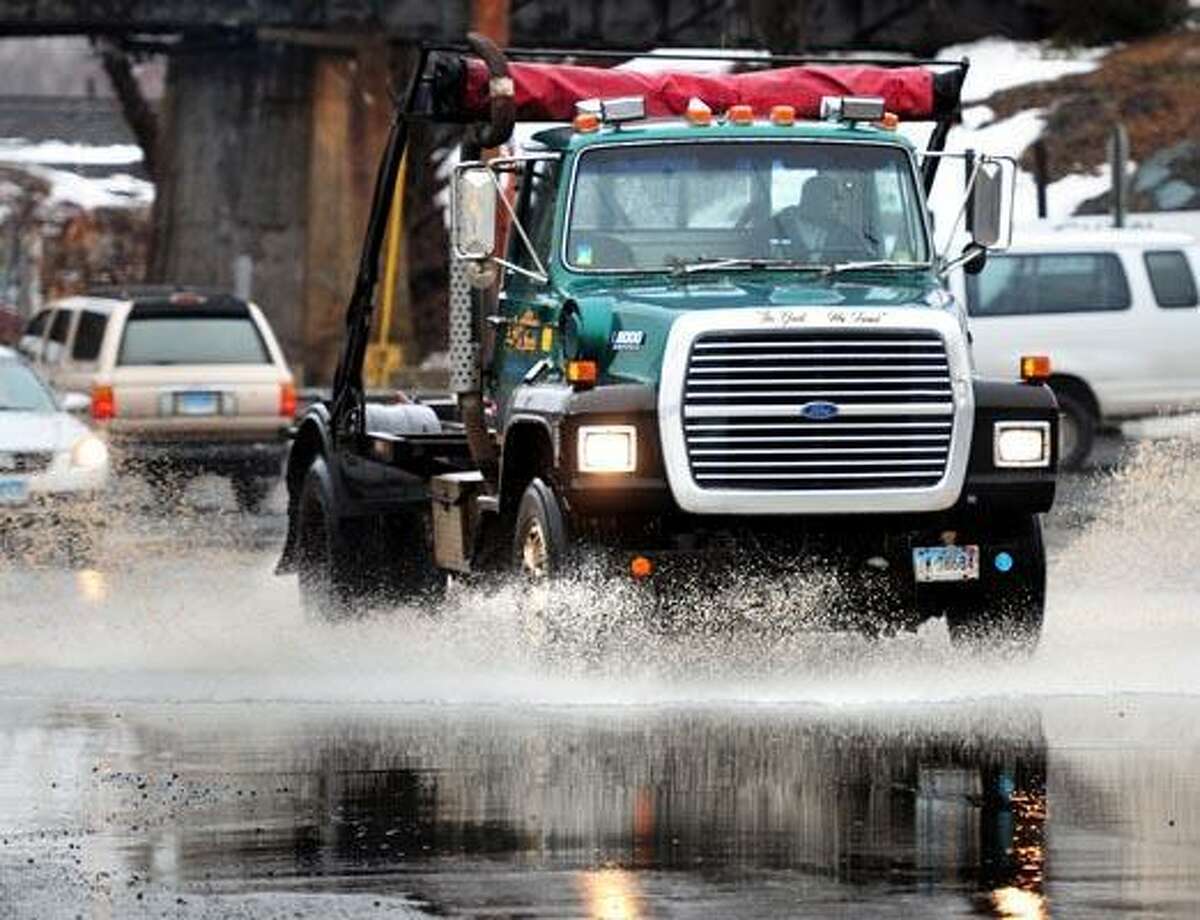 A truck drives through standing water on Middletown Ave. in New Haven Friday. (Photo by Arnold Gold/New Haven Register)