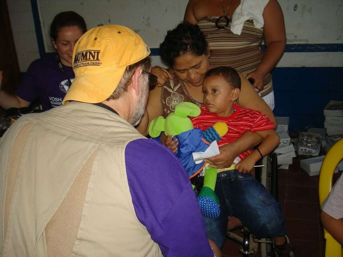 Dr. Matthew Blondin gets acquainted with a young patient at the 14th annual VOSH-CT charitable trip to Nicaragua, where he and other doctors provided a week of free eye care clinics to needy residents.