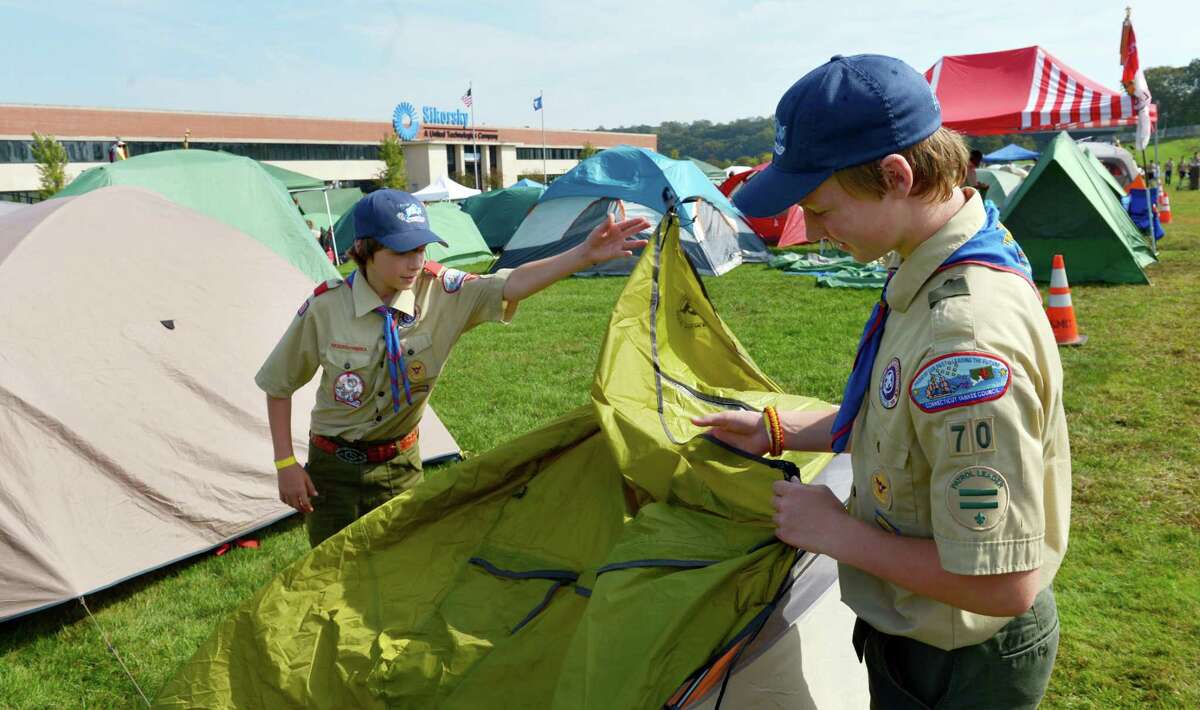 Boy Scouts Camden Fowler, left, and Matt Hess, right, of Troop 70 in Newtowne pitch a tent during the 11th annual Camp Sikorsky on the grounds of the main Sikorsky plant in Stratford.