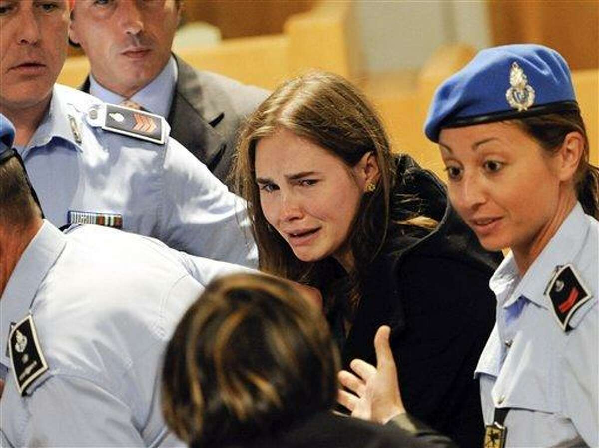 Amanda Knox cries following the verdict that overturns her conviction and acquits her of murdering her British roomate Meredith Kercher, at the Perugia court, Italy, Monday Oct. 3, 2011. An Italian appeals court has thrown out Amanda Knox's murder conviction and ordered the young American freed after nearly four years in prison for the death of her British roommate. Knox collapsed in tears after the verdict was read out Monday. Her co-defendant, Raffaele Sollecito, also was cleared of killing 21-year-old Meredith Kercher in 2007. (AP Photo/Lapresse) ITALY OUT