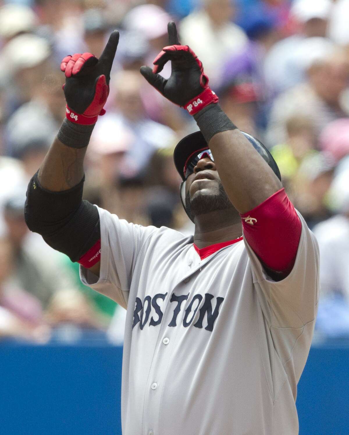 Boston Red Sox's David Ortiz celebrates a three-run home run in the fifth inning of MLB baseball game action against the Toronto Blue Jays in Toronto, Sunday, June 12, 2011. (AP Photo/The Canadian Press, Darren Calabrese)