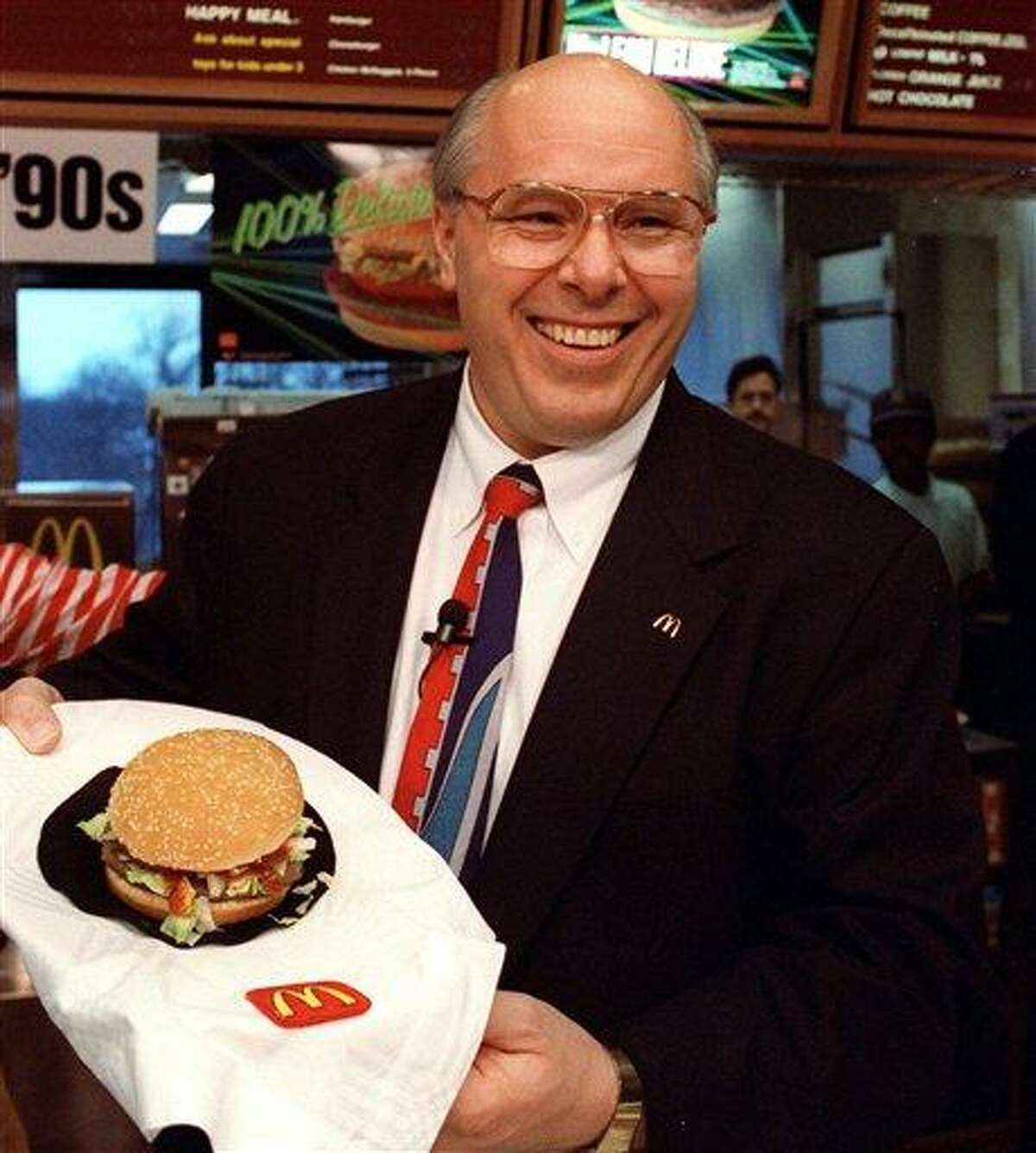 FILE - In this file photo of March 13, 1991, (then) McDonald's Corp. President Ed Rensi shows off the McLean Deluxe Burger during a news conference at the company's Oak Brook, Ill., headquarters. The lower fat hamburger made with seaweed derivative never really caught on with customers. (AP Photo/Ralf-Finn Hestoft, File)