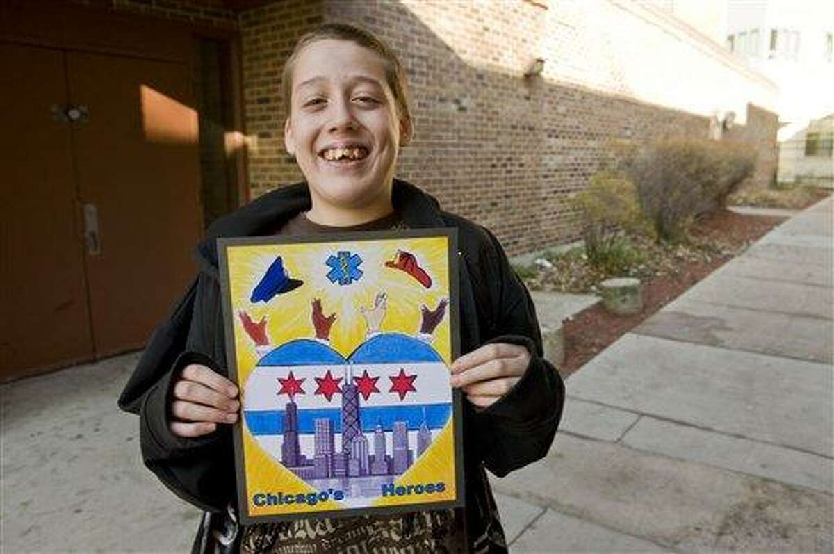This photo taken Dec, 12, 2011 shows 15-year-old Herbert Pulgar, holding his winning design for the 2012-13 city of Chicago vehicle sticker that was axed Wednesday by Chicago City Clerk Susana Mendoza contending some may believe it depicts street gang signs. Associated Press