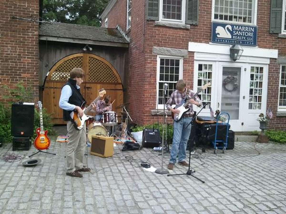 The Revival jams some rock tunes to an audience in Cobble Court.