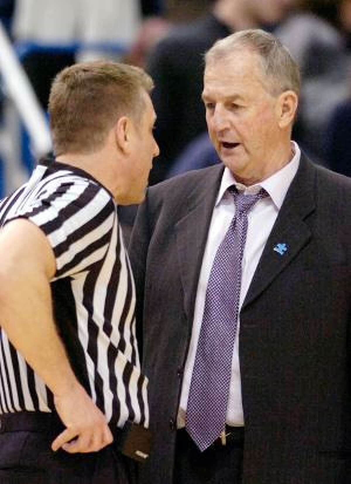 AP Connecticut coach Jim Calhoun speaks with an official during the first half of his team's 78-70 victory over Georgetown on Feb. 16 in Hartford. Calhoun released a statement Friday responding to the NCAA's findings and said "the buck stops here."