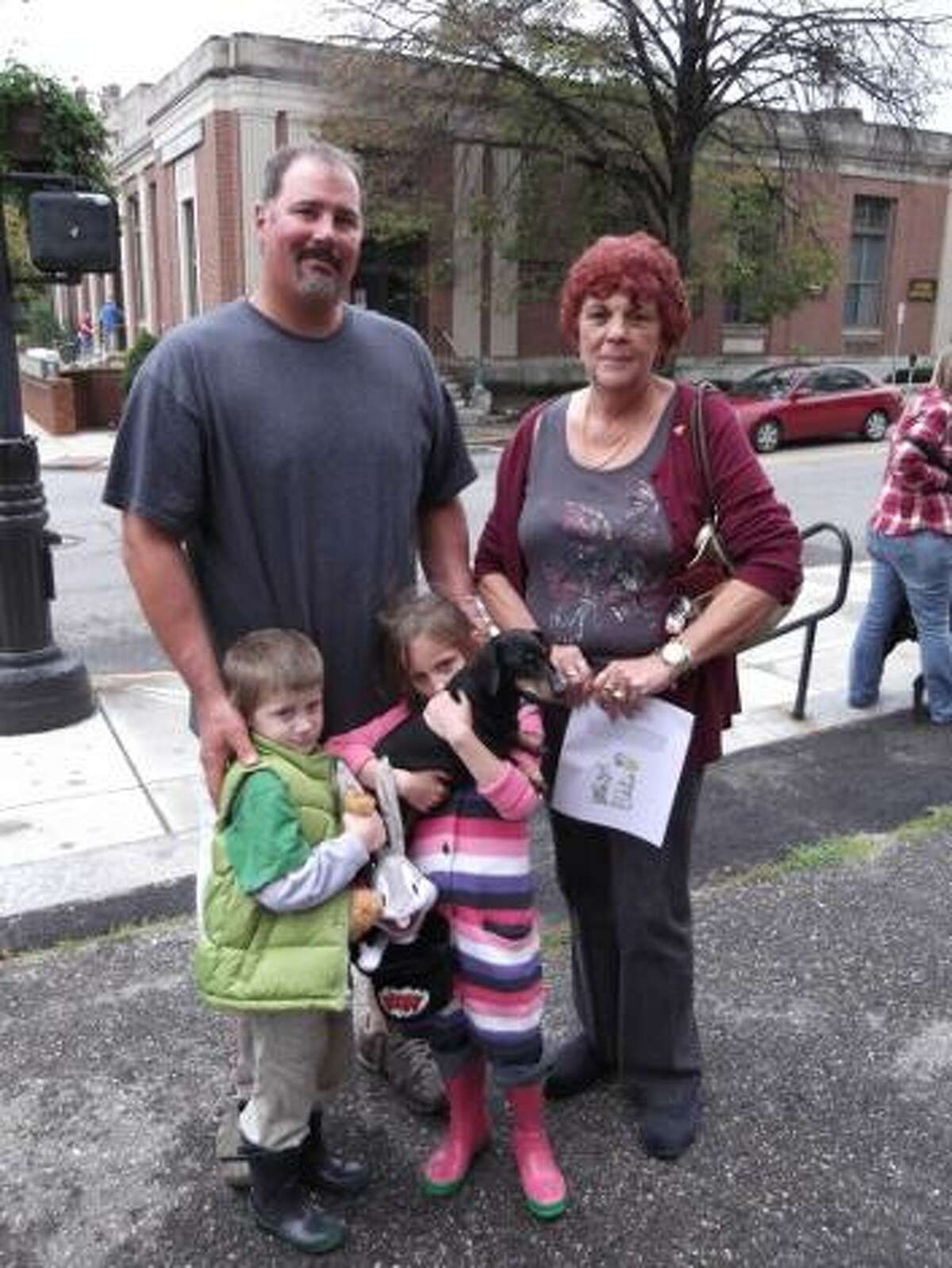 KAITLYN YEAGER/Register Citizen Dog family: Richard Ricupero and his children Isabella and Nicholas wait with Grandma Kenneson and their dog Blackie for the Blessing of the Animals to begin at St. Francis Church. This year's event was the second blessing and first pet parade for the church.