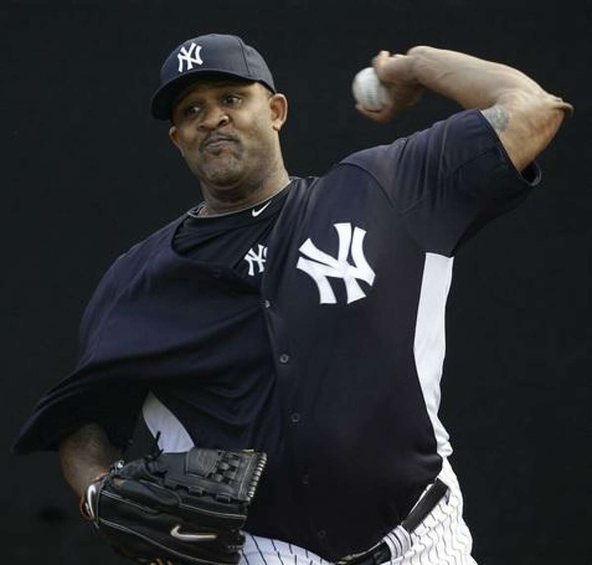 New York Yankees pitcher CC Sabathia throws in the bullpen during a baseball spring training workout Tuesday, Feb. 22, 2011, at Steinbrenner Field in Tampa, Fla. (AP Photo/Charlie Neibergall)