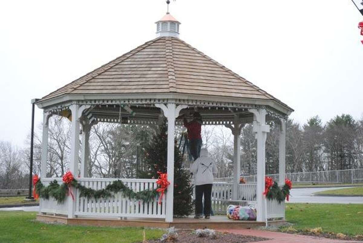 MIKE AGOGLIATI/ Register Citizen Workers prepare the gazebo in the Harwinton town hall complex Tuesday for the Harwinton Hometown Holiday event scheduled for Saturday, Dec. 3. See story on Page A8.