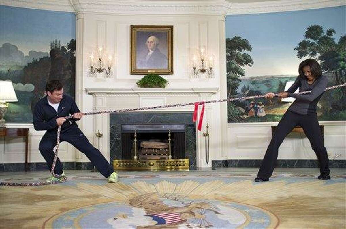 In this image released by The White House, first lady Michelle Obama participates in a tug of war with television host Jimmy Fallon in the Blue Room of the White House during a taping of "Late Night with Jimmy Fallon," for the second anniversary of the "Let's Move!" initiative on Jan 25, 2012, at the White House in Washington. The segment is scheduled to air on Tuesday. Associated Press