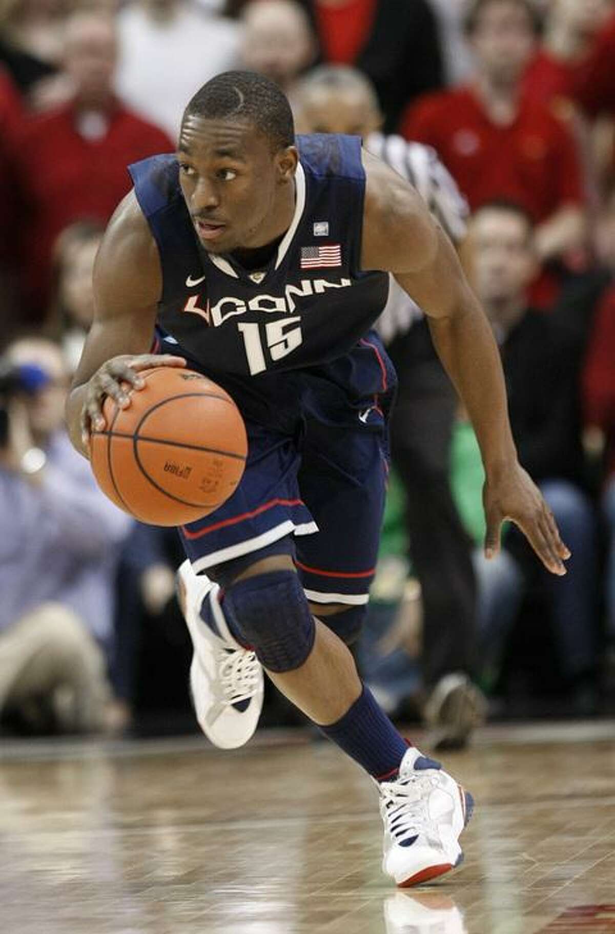 Connecticut 's Kemba Walker drives the ball upcourt during the first half of their NCAA college basketball game against Louisville in Louisville, Ky., Friday, Feb. 18, 2011. (AP Photo/Ed Reinke)