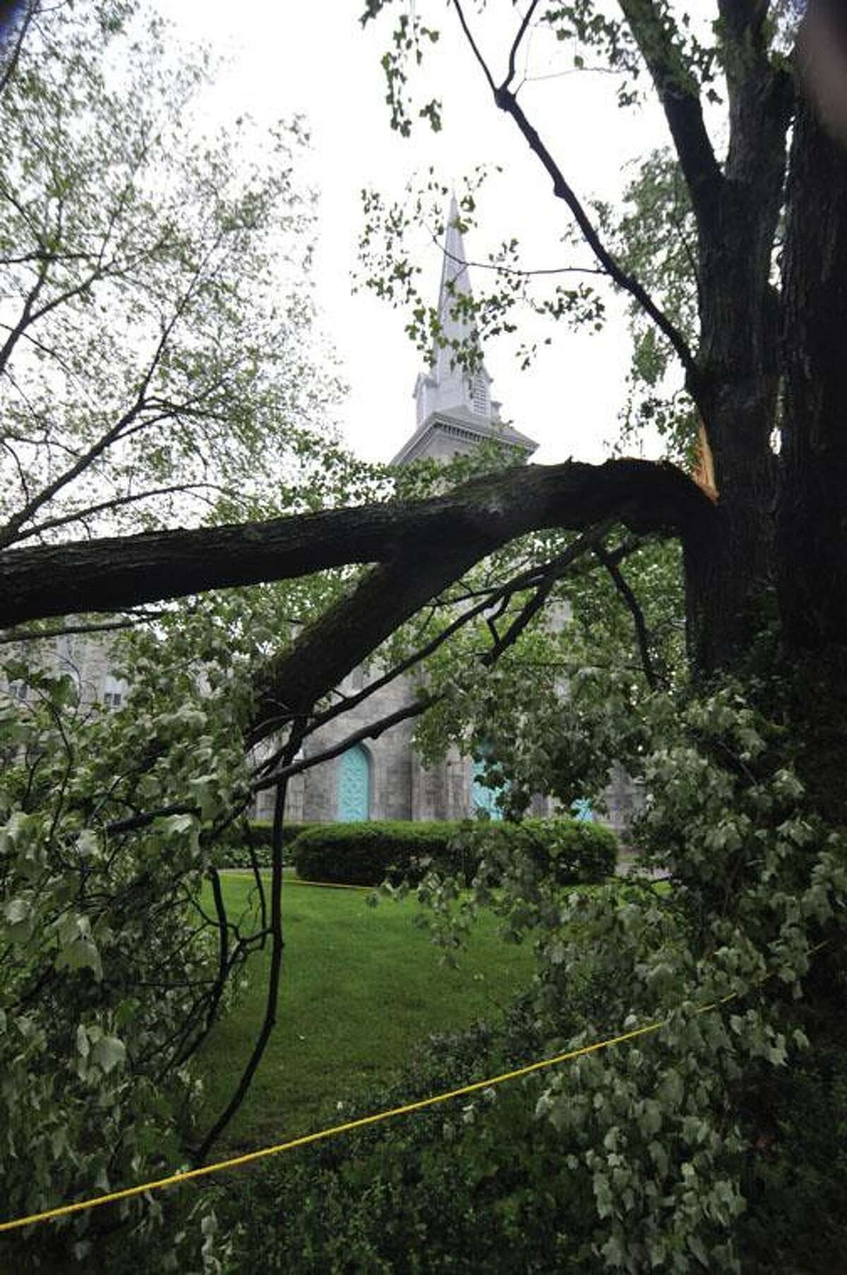 RICK THOMASON / Register CitizenBroken and battered trees sit as a reminder of the fury of Thursday afternoon's storms that blew through Torrington and much of Litchfield County. Two trees were broken on the grounds of Center Congregation Church on Main Street in Torrington.