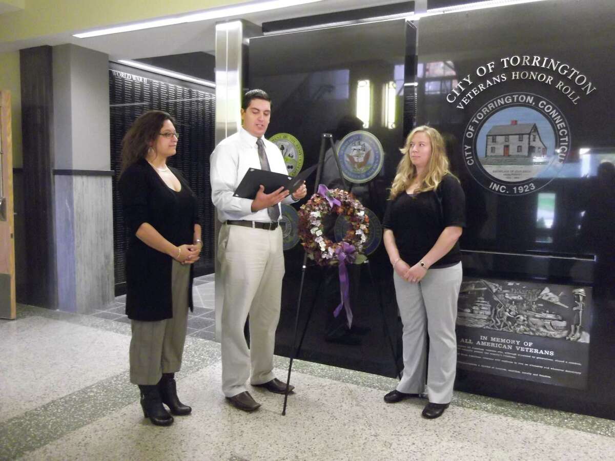 Sarah Bogues/Register Citizen Staff Torrington Mayor Ryan Bingham stood with members of the Susan B. Anthony Project and announced on Monday morning that October is Domestic Violence Awareness Month.