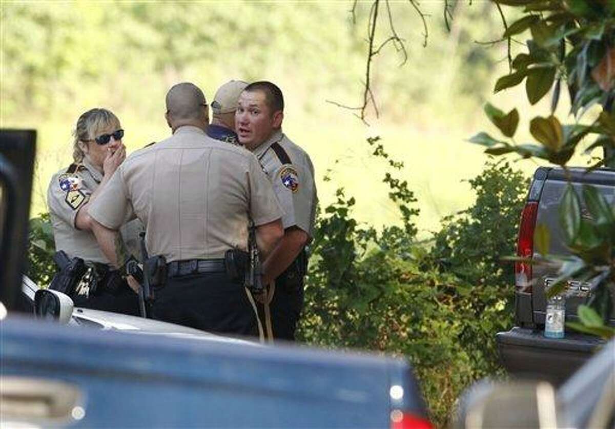 Law enforcement officials are on the scene of a home in Hardin, Texas Tuesday, June 7, 2011, after receiving an anonymous tip that multiple dismembered bodies were buried there. A sheriff's spokesman said officials were seeking a search warrant for the property. (AP Photo/Houston Chronicle, Nick de la Torre)