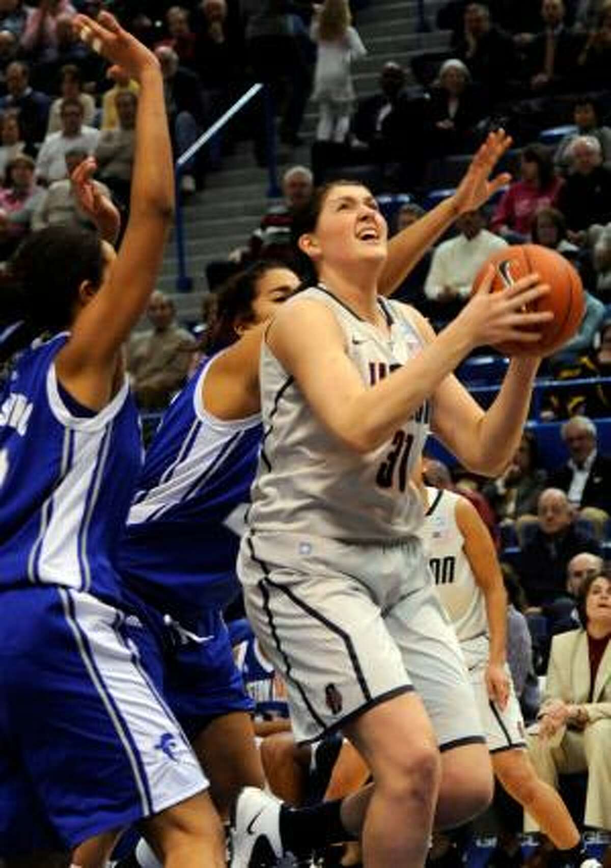 AP Connecticut's Stefanie Dolson comes in for a shot past Seton Hall defenders during the first half of Tuesday's game in Hartford. The Huskies won 80-59.