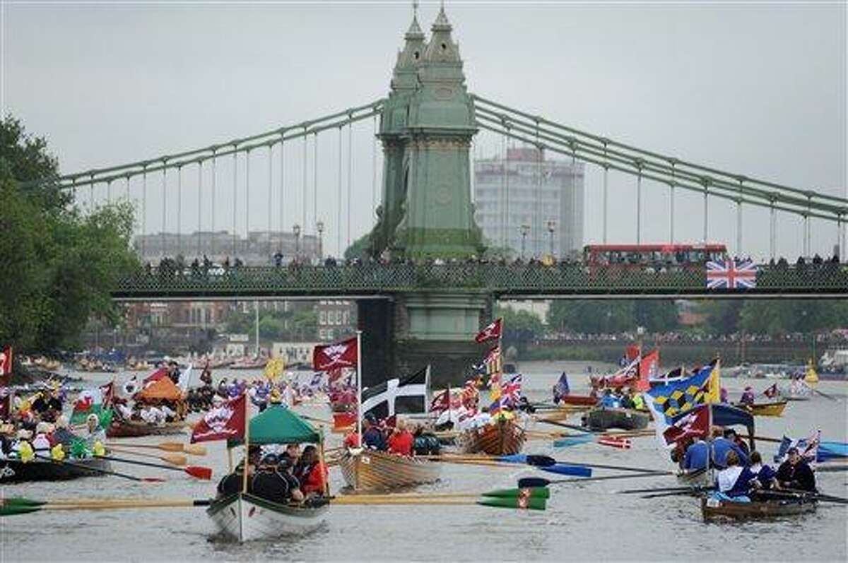 Boats begin to gather near Hammersmith Bridge on the River Thames, London, during the Diamond Jubilee river pageant Sunday. More than 1,000 boats were to sail down the River Thames on Sunday in a flotilla tribute to Queen Elizabeth II's 60 years on the throne that organizers are calling the biggest gathering on the river for 350 years. Associated Press