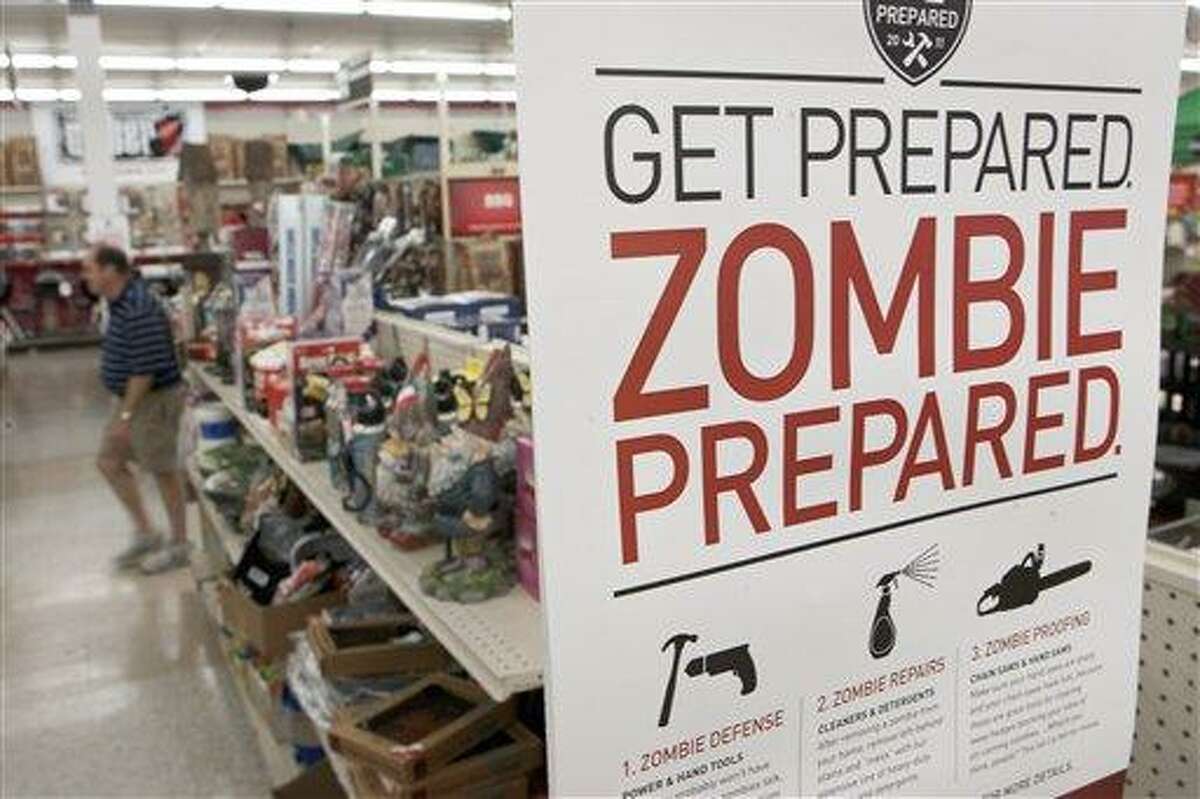 In this October 2011 file photo, a sign promoting zombie preparedness displays in a hardware store in Omaha, Neb. After several gory incidents that have been reported around the country recently, online zombie talk has grown. Associated Press