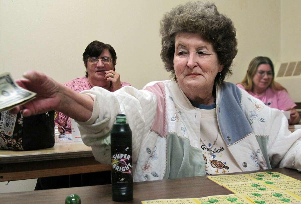 DEBBI MORELLO/Register Citizen Edie Mozicato just called "Bingo in the room!" and takes her money at St. Maron's Church on Sunday. The room to which Mozicato refers is the smoking room, cigarettes or cigars, and they say luck is in the room.