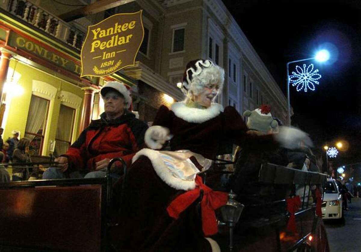 DEBBI MORELLO/ Register Citizen Mrs. Claus appeared at The Toy Shower at the Yankee Pedlar Inn on Friday and jumped onto the horse drawn carriage to take a ride down Main St. with local children and their parents.