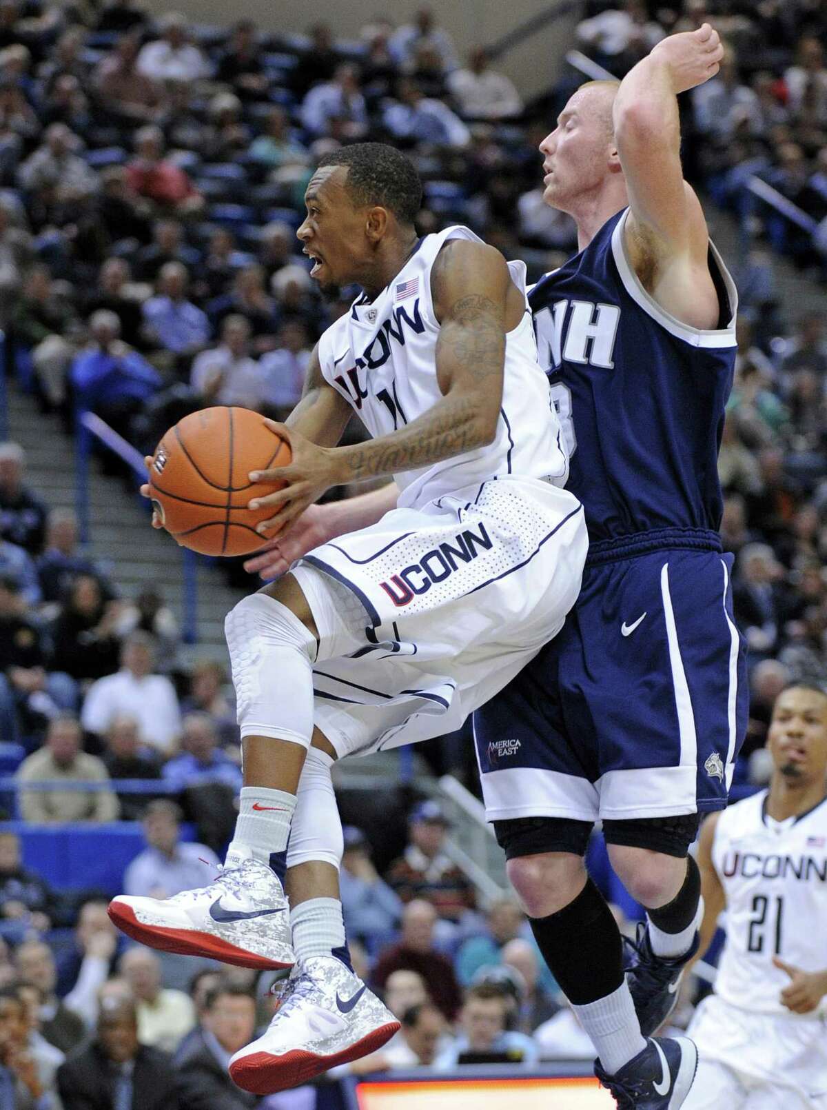 Connecticut's Ryan Boatright, left, drives past New Hampshire's Chandler Rhoads during the second half of an NCAA college basketball game in Hartford, Conn., Thursday, Nov. 29, 2012. Boatright scored a team-high 19 points in Connecticut's 61-53 victory. (AP Photo/Fred Beckham)
