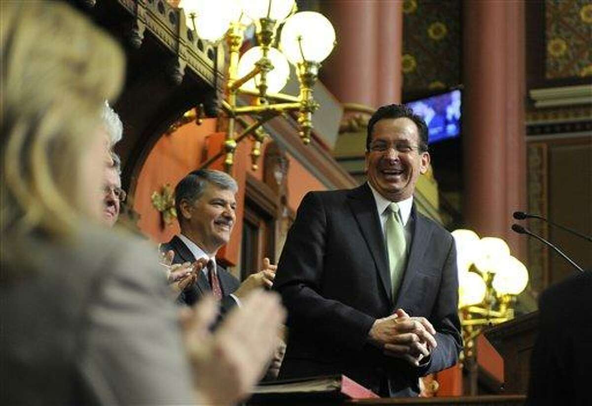 Connecticut Gov. Dannel P. Malloy reacts as he presents his first two-year budget, during a joint session of the General Assembly at the Capitol, in Hartford, Conn., Wednesday, Feb. 16, 2011. The plan raises taxes across-the-board, seeks $2 billion in savings from state employees and attempts to cut spending without stripping programs for the needy. (AP Photo/Jessica Hill)
