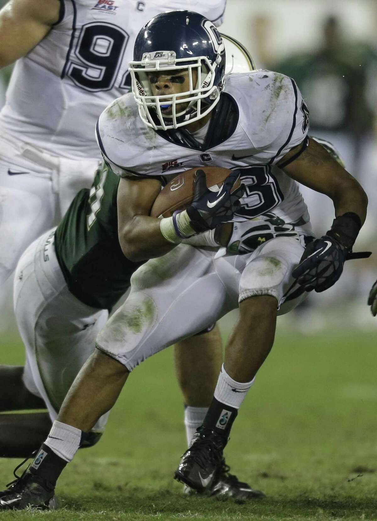 Connecticut running back Lyle McCombs (43) runs with the ball during the fourth quarter of an NCAA college football game against South Florida Saturday, Nov. 3, 2012, in Tampa, Fla. (AP Photo/Chris O'Meara)