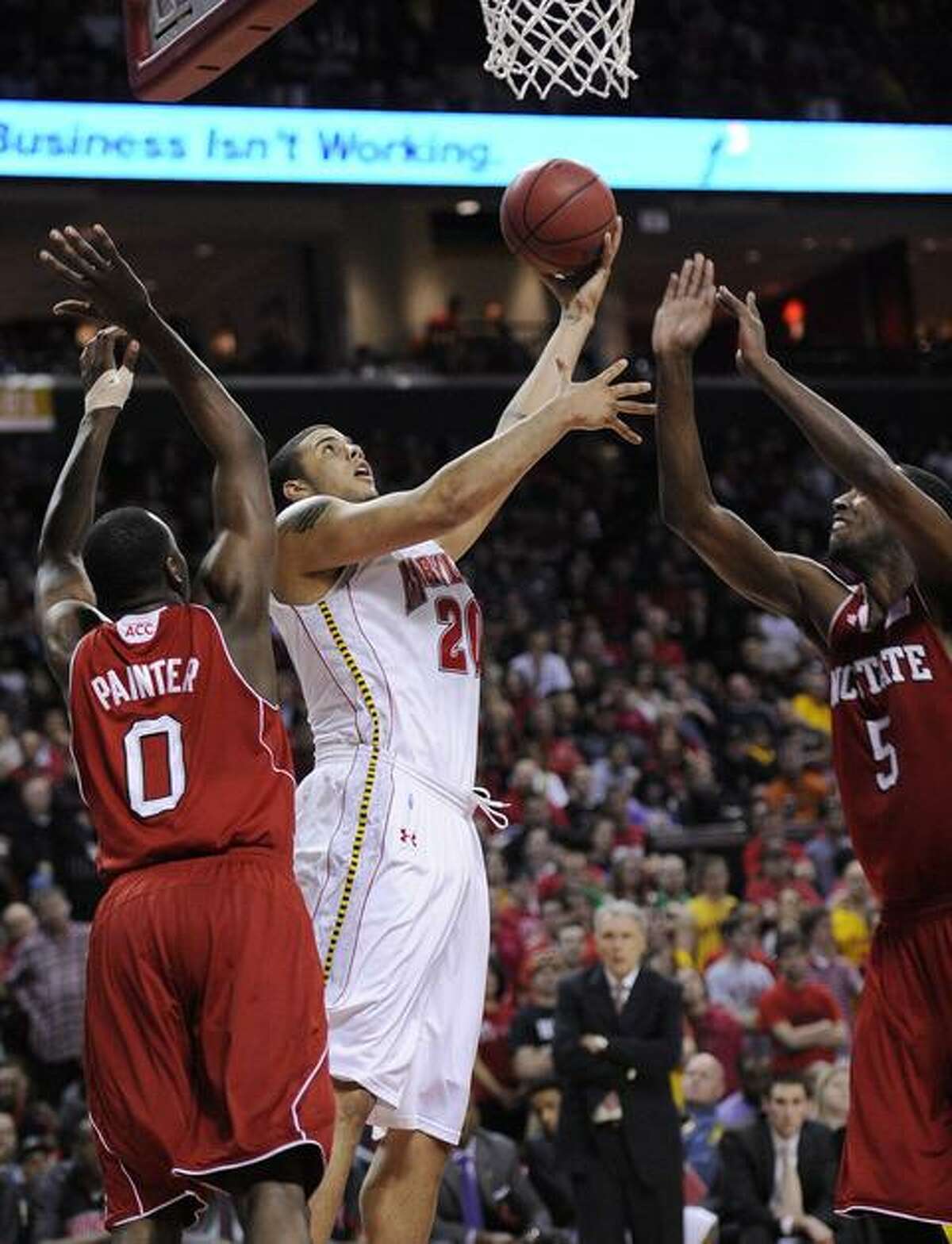 Maryland forward Jordan Williams, center, goes to the basket against North Carolina State's DeShawn Painter (0) and C.J. Leslie (5) during the second half of an NCAA college basketball game, Sunday, Feb. 20, 2011, in College Park, Md. Maryland won 87-80. (AP Photo/Nick Wass)