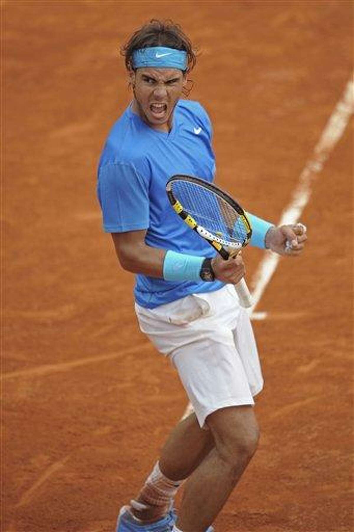 Rafael Nadal of Spain clenches his fist as he takes the second set in his match against Roger Federer of Switzerland in the men's final of the French Open tennis tournament in Roland Garros stadium in Paris, Sunday. (AP Photo/Laurent Baheux)