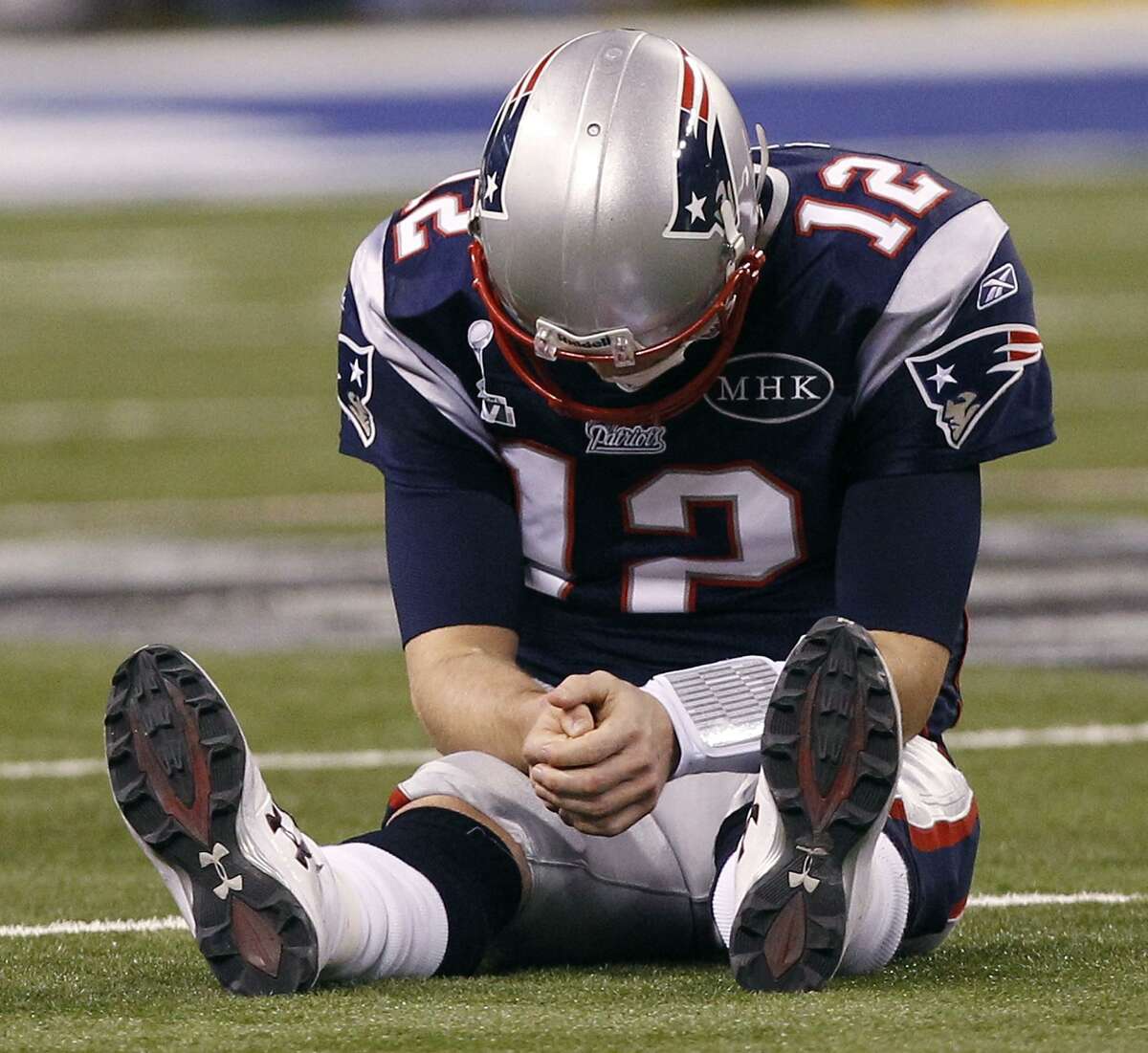 New England Patriots quarterback Tom Brady reacts after New York Giants linebacker Chase Blackburn intercepted Brady's pass intended for tight end Rob Gronkowski during the second half of the NFL Super Bowl XLVI football game, Sunday, Feb. 5, 2012, in Indianapolis. (AP Photo/Paul Sancya)