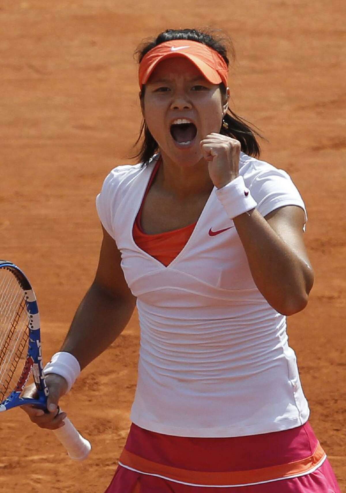 ASSOCIATED PRESS China's Li Na reacts as she plays Italy's Francesca Schiavone during their women's final match for the French Open tennis tournament at the Roland Garros stadium, Saturday in Paris.