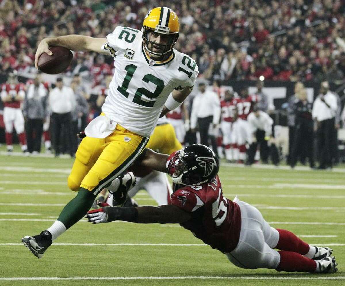 ASSOCIATED PRESS In this Jan. 15, 2011, file photo, Green Bay Packers quarterback Aaron Rodgers (12) scrambles past Atlanta Falcons linebacker Curtis Lofton (50) on a 7-yard touchdown run during the second half of an NFL divisional playoff game in Atlanta. Rodgers was selected as The Associated Press' NFL Most Valuable Player Award on Saturday.