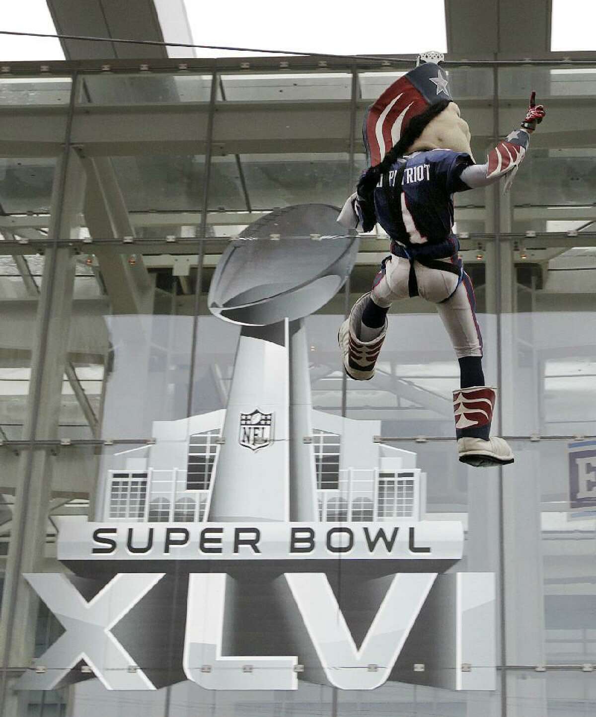 ASSOCIATED PRESS New England Patriots football team mascot Pat Patriot rides the zip line at Super Bowl Village in Indianapolis on Saturday. The New England Patriots will play the New York Giants in Super Bowl XLVI in Indianapolis Sunday.