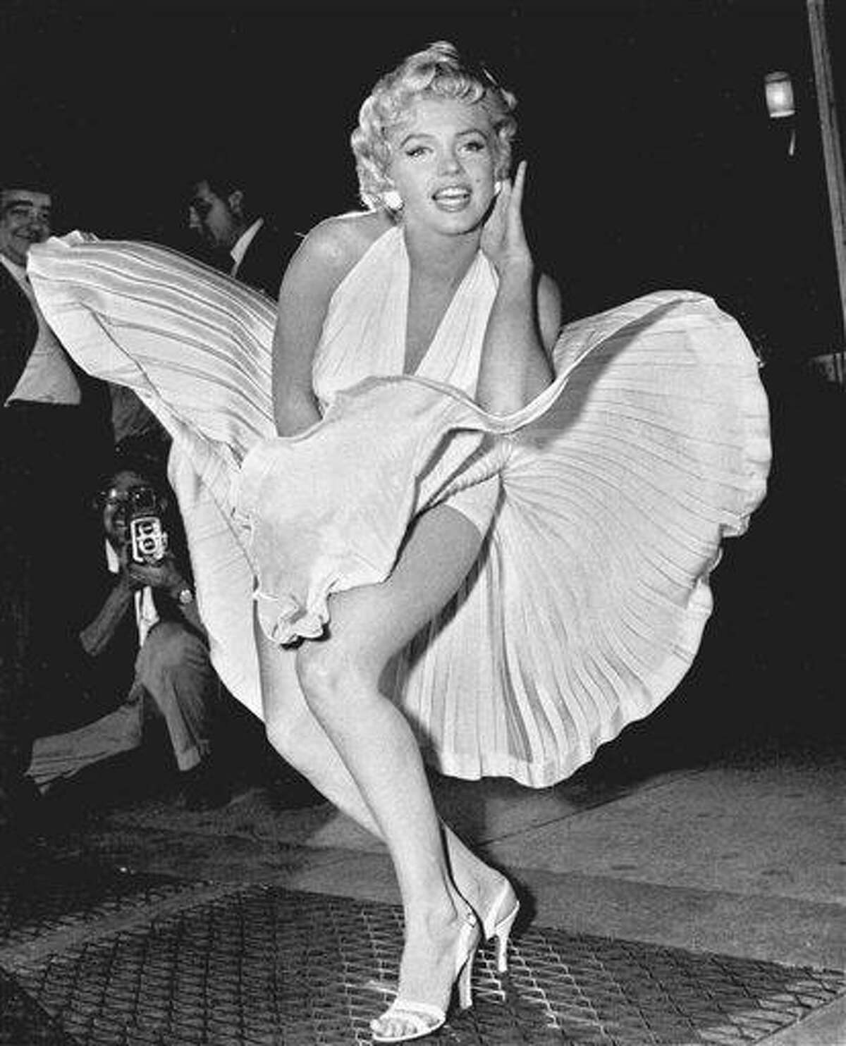 FILE - In this Sept. 9, 1954 file photo, Marilyn Monroe poses over the updraft of New York subway grating while in character for the filming of "The Seven Year Itch" in Manhattan. The former Norma Jean Baker modeled and starred in 28 movies grossing $200 million. Sensual and seductive, but with an air of innocence, Monroe became one of the world's most adored sex symbols. She died alone by suicide, at age 36 in her Hollywood bungalow. (AP Photo/Matty Zimmerman, File)