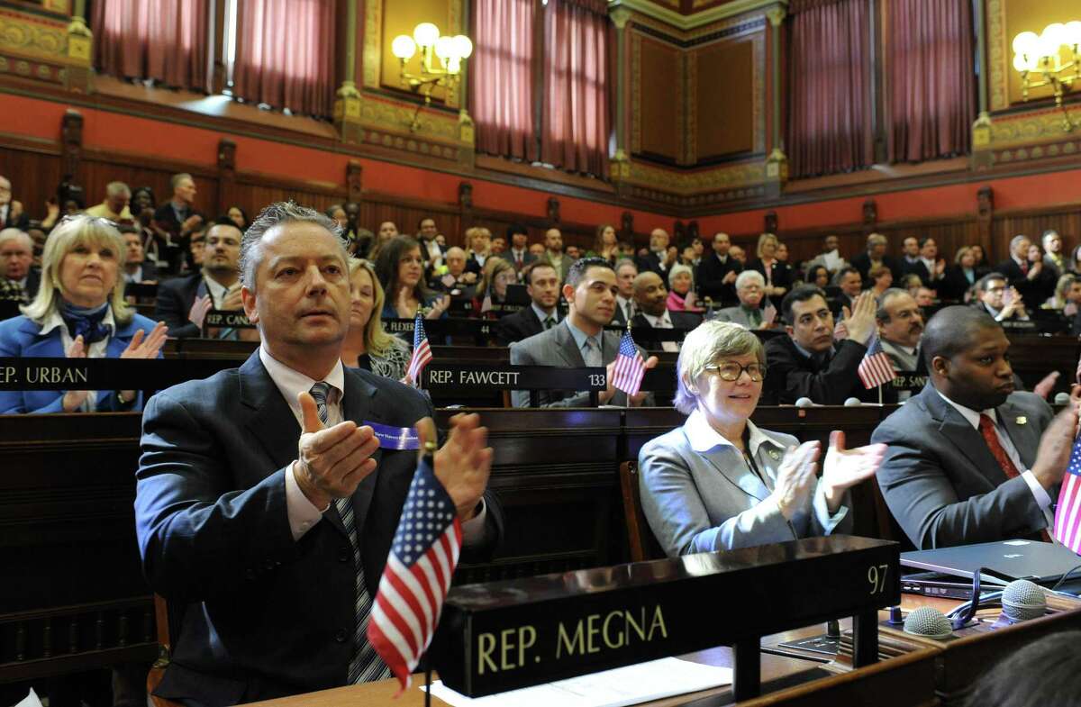 Members of the House react as Connecticut Gov. Dannel P. Malloy presents his first two-year budget, during a joint session of the General Assembly at the Capitol, in Hartford, Conn., Wednesday, Feb. 16, 2011. The plan raises taxes across-the-board, seeks $2 billion in savings from state employees and attempts to cut spending without stripping programs for the needy. (AP Photo/Jessica Hill)