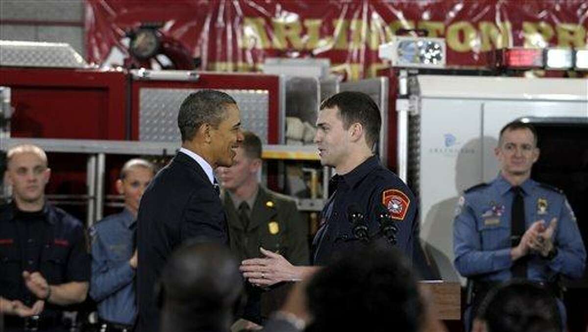 President Barack Obama shakes hands with Arlington County firefighter and U.S. Marine Corps veteran Lt. Jacob Johnson, who served in Iraq, after he was introduced to speak about the economy during an event at Fire Station #5 in Arlington, Va., Friday. Obama has called for putting unemployed veterans to work in conservation projects on public lands. Associated Press