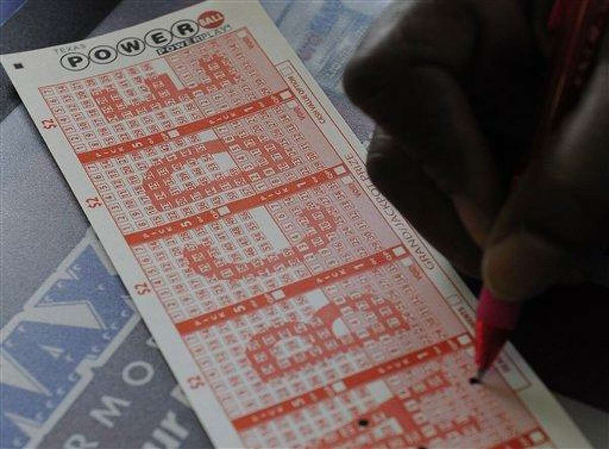 A customer fills in his numbers on a Powerball ticket Monday in Houston for a chance to win. Associated Press