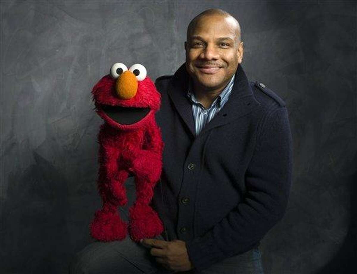 Elmo puppeteer Kevin Clash poses with the "Sesame Street" muppet in the Fender Music Lodge during the 2011 Sundance Film Festival in Park City, Utah. Associated Press file photo