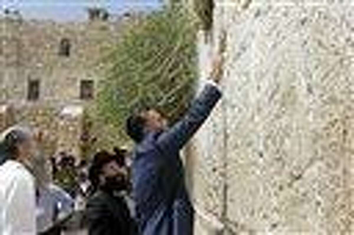 Republican presidential candidate and former Massachusetts Gov. Mitt Romney places a prayer note as he visits the Western Wall in Jerusalem, Sunday, July 29, 2012. Associated Press