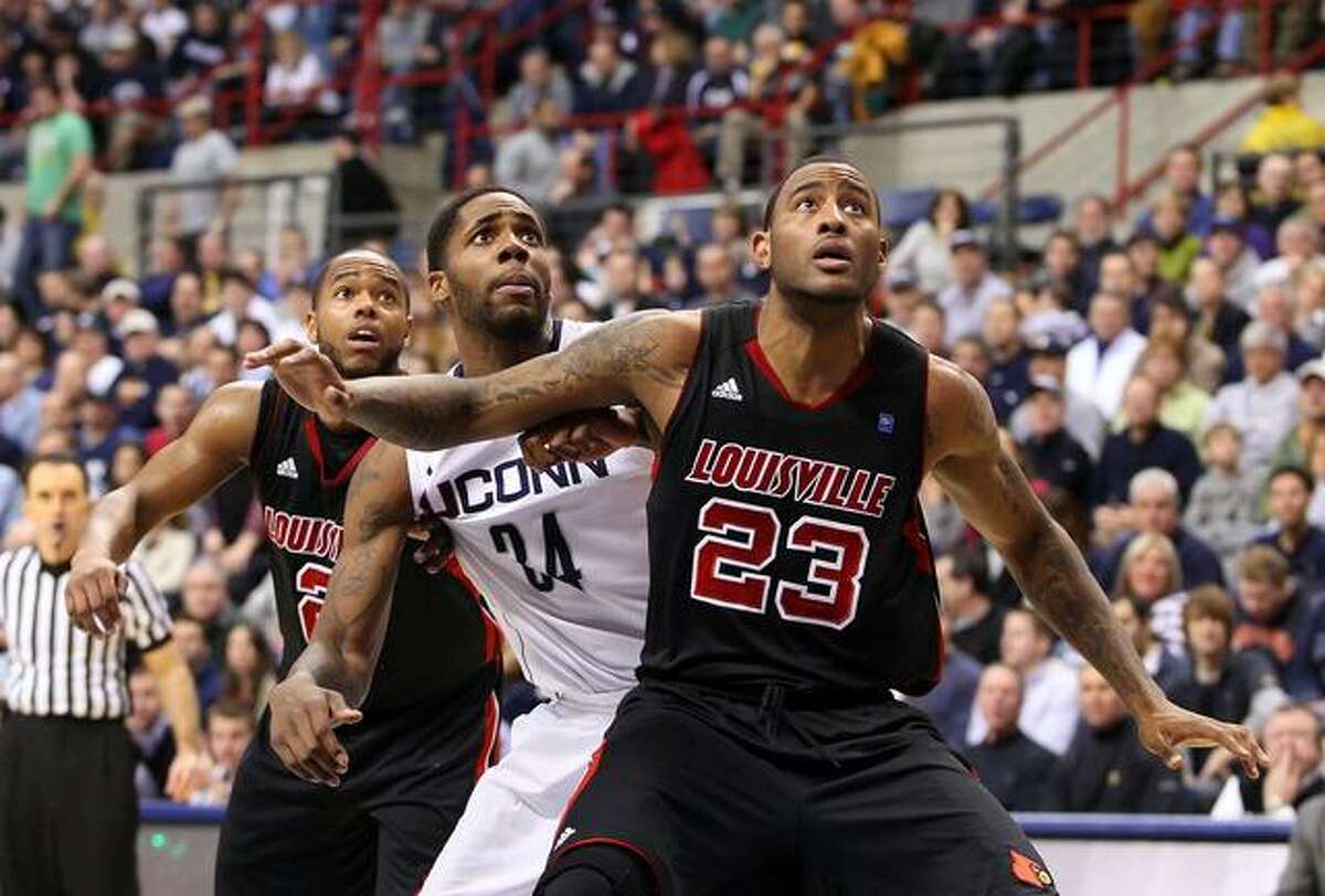 January 29, 2011: Louisville Cardinals forward Terrence Jennings (23), Connecticut Huskies forward/center Alex Oriakhi (34) and Louisville Cardinals guard Preston Knowles (2) battle for position after free throw attempts at Gampel Pavilion in Storrs, Connecticut. Louisville defeated Connecticut in double overtime 79-78. (Cal Sports Media via AP Images)