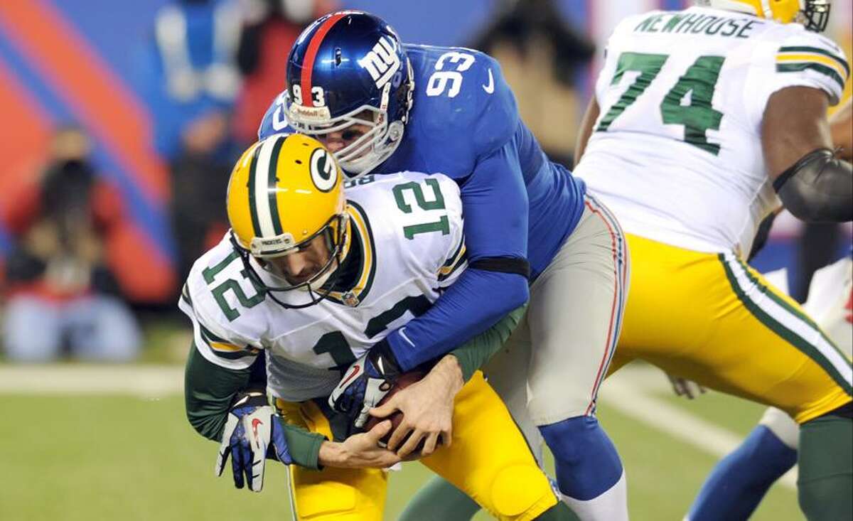 New York Giants middle linebacker Chase Blackburn gets past Green Bay Packers' Marshall Newhouse (74) to sack Aaron Rodgers (12) during the first half of an NFL football game Sunday, Nov. 25, 2012 in East Rutherford, N.J. (AP Photo/Bill Kostroun)