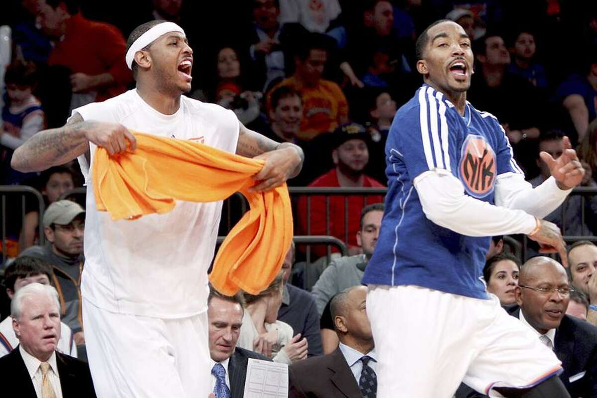 New York Knicks' Carmelo Anthony, left, and J.R. Smith celebrate on the bench during the second half of an NBA basketball game against the Detroit Pistons in New York, Sunday, Nov. 25, 2012. The Knicks won 121-100. (AP Photo/Seth Wenig)