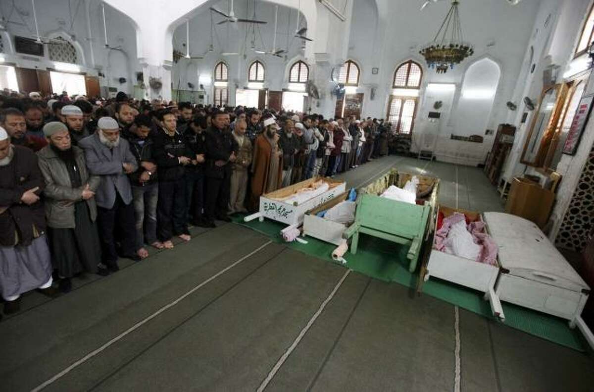Mourners pray next to the bodies of victims of Wednesday's soccer violence at Port Said stadium during their funeral in Port Said Thursday. Seventy-four people were killed when supporters clashed at an Egyptian soccer match, prompting fans and politicians on Thursday to turn on the ruling army for failing to prevent the deadliest incident since Hosni Mubarak was ousted. (Reuters/Mohamed Abd El-Ghany)