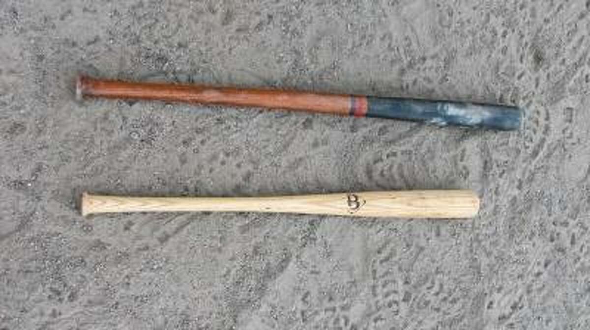 JOHN NESTOR/Register Citizen Correspondent A vintage bat (top) like the ones used Saturday compared to a modern wood bat.