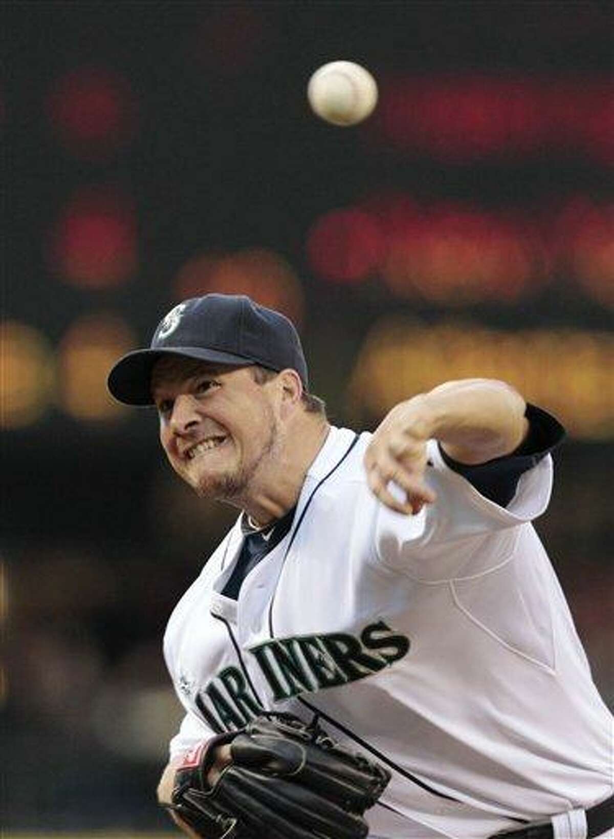 Seattle Mariners starting pitcher Erik Bedard throws to the Los Angeles Angels during the first inning of a baseball game Wednesday, June 15, 2011, in Seattle. (AP Photo/Elaine Thompson)