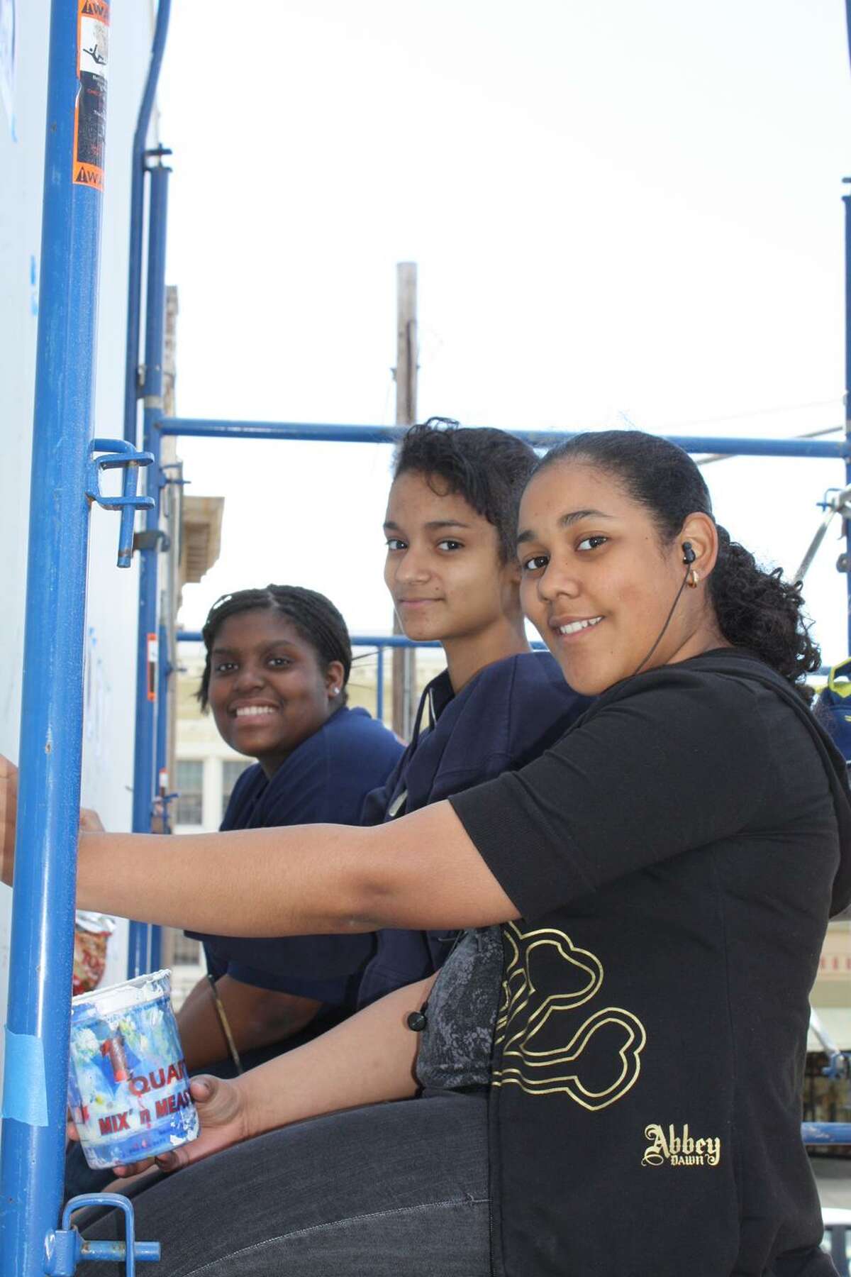 Submitted photos From left, students Daisy Peguero, Jemy Hernandez and Stephanie Pimenta work on their mural project.