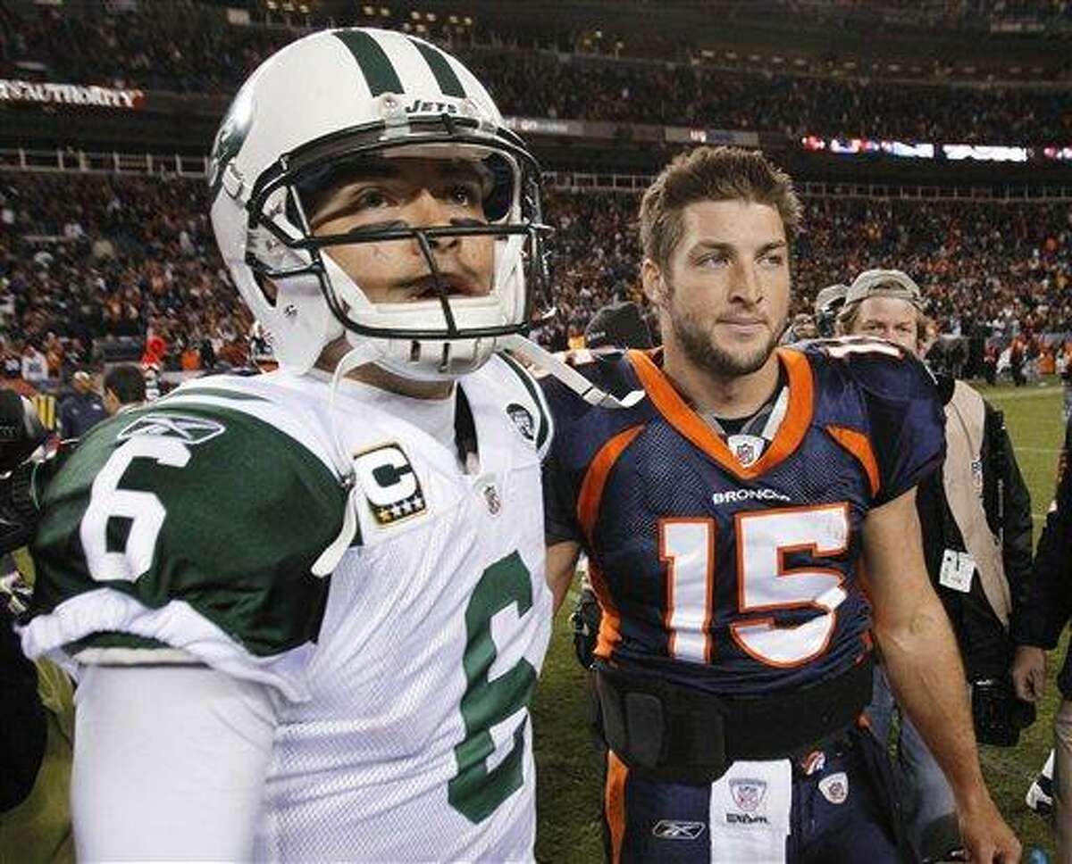 FILE - In this Nov. 17, 2011 file photo, New York Jets quarterback Mark Sanchez (6) and Denver Broncos quarterback Tim Tebow (15) walk off the field together after an NFL football game, in Denver. Tebow has been traded from the Denver Broncos to the New York Jets. (AP Photo/Barry Gutierrez, File)