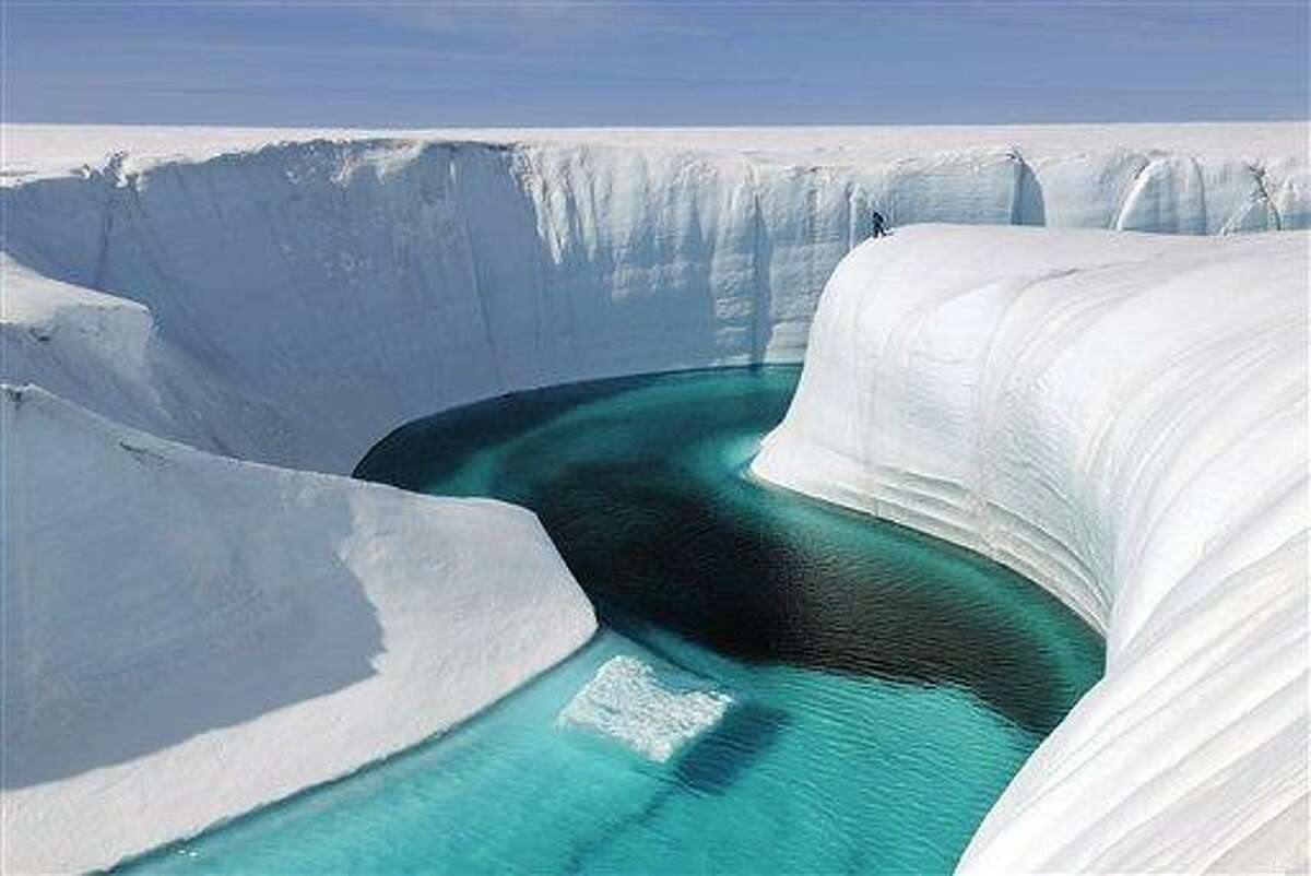 This 2009 photo released by Extreme Ice Survey shows Birthday Canyon in Greenland furing the filming of "Chasing Ice." The film, about climate change, follows National Geographic photographer James Balog across the Arctic as he deploys revolutionary time-lapse cameras designed to capture a multi-year record of the world's changing glaciers. (AP Photo/Extreme Ice Survey, James Balog)