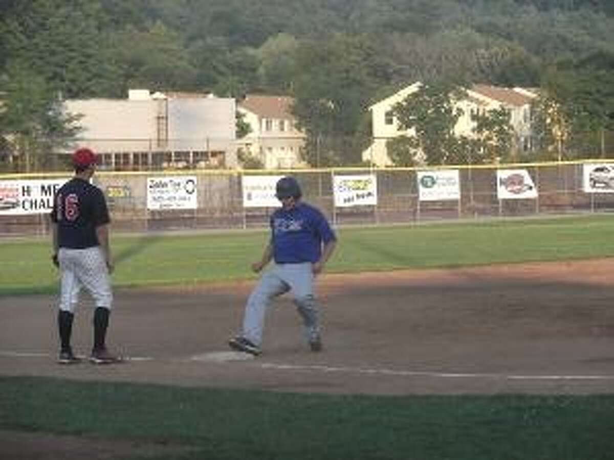 KEVIN D. ROBERTS/Register Citizen Winsted's Dan Williams hustles to third base with a stand-up triple in front of Torrington Sports Palace's Kyle Sanford during Monday night's Connie Mack game against Torrington at Fuessenich Park in Torrington. Williams later scored. Sports Palace won the game 8-4.