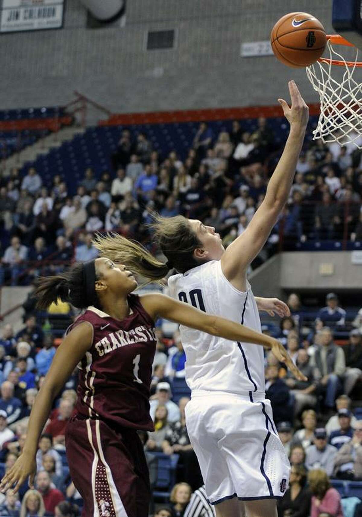 Connecticut's Breanna Stewart, right, drives past Charleston's Alyssa Frye during the first half of an NCAA college basketball game in Storrs, Conn., Sunday, Nov. 11, 2012. Stewart scored a game-high 21 points and Frye a team-high 14 in Connecticut's 103-39 victory. (AP Photo/Fred Beckham)