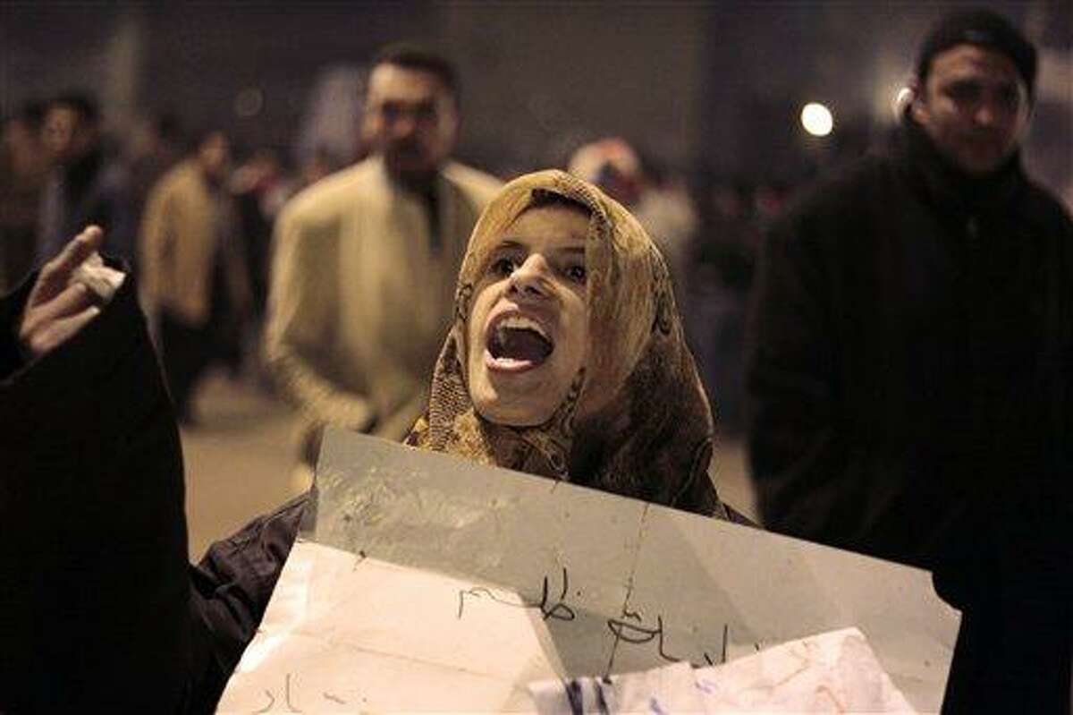 An Egyptian woman chants anti-government slogans during a protest in Tahrir (Liberation) square, early Wednesday, Feb. 2, 2011. Egyptian President Hosni Mubarak announced he will not run for a new term in September elections but rejected protesters' demands he step down immediately and leave the country, vowing to die on Egypt's soil, after a dramatic day in which a quarter-million Egyptians staged their biggest protest yet calling on him to go. (AP Photo/Lefteris Pitarakis)