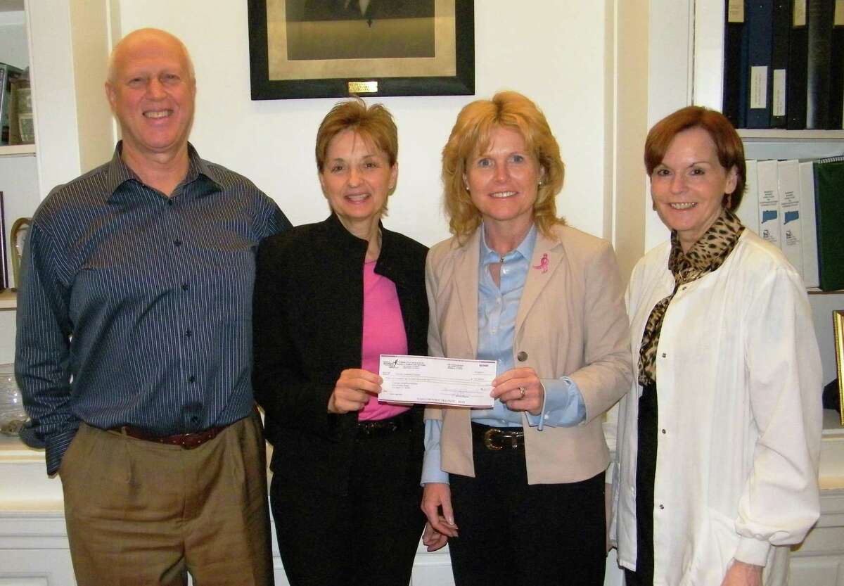 Submitted photo From left, Charlotte Hungerford Hospital President Dan McIntyre and Patient Relations Director Marty Mancuso accept a $63,000 check from Susan G. Komen For the Cure Executive Director Anne Morris with CHH Certified Breast Health Navigator Leslie Handleman, R.N.